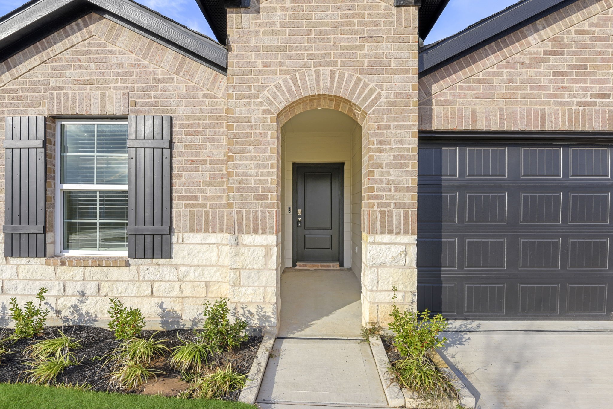 30906 Rockstock Road Fulshear, TX 77441 - Photo 6 of 43 a front view of a house with a garden