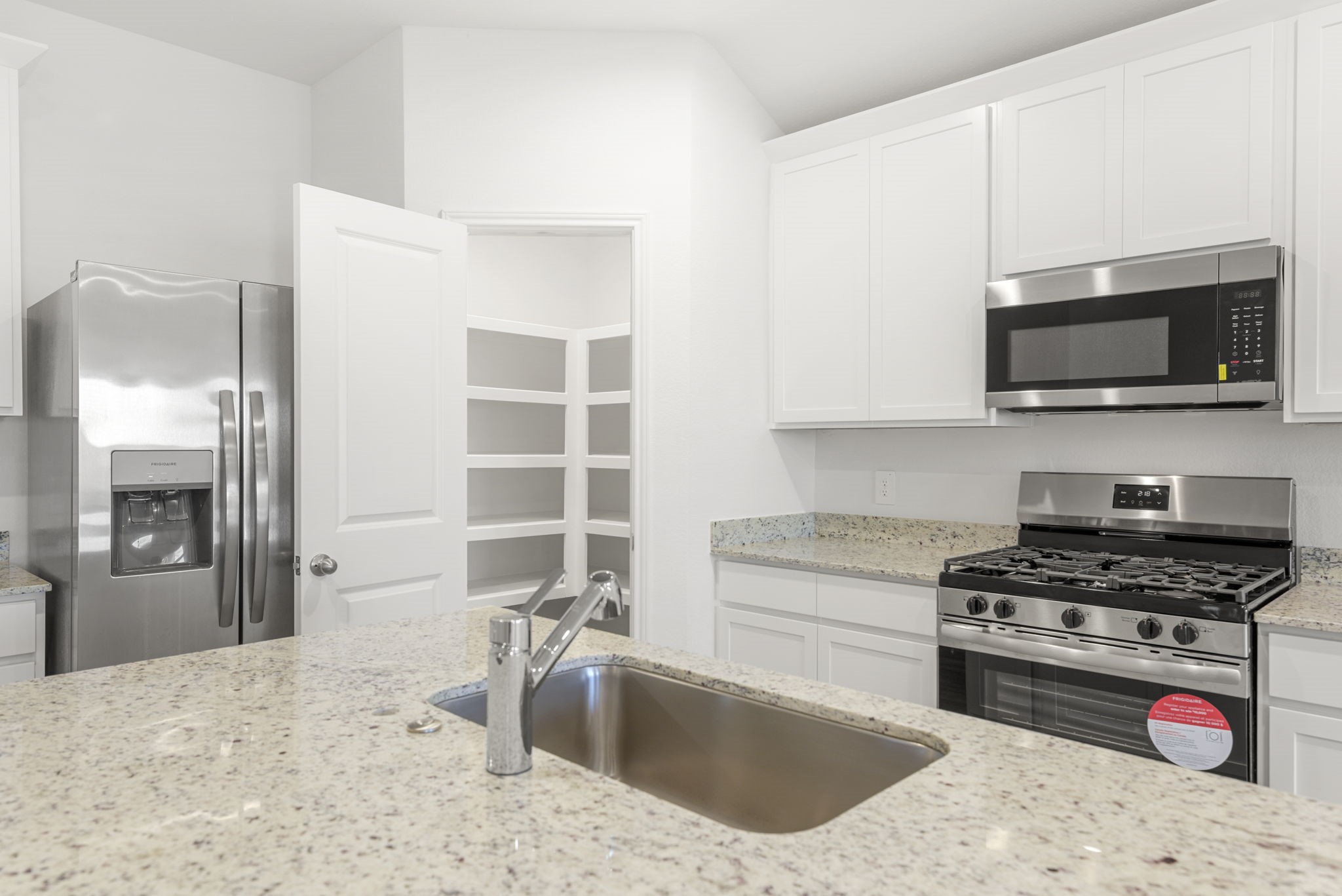 30906 Rockstock Road Fulshear, TX 77441 - Photo 10 of 43 a kitchen with stainless steel appliances granite countertop a sink stove and refrigerator
