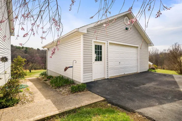 a view of house with backyard and sitting area