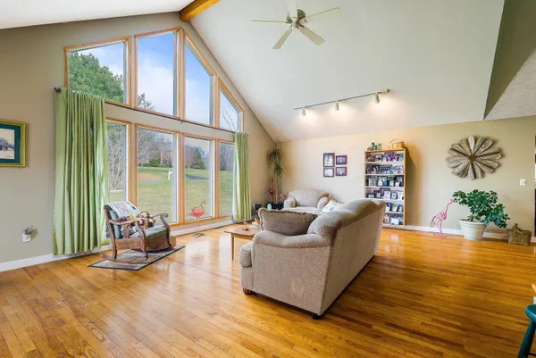 a living room with furniture and a wooden floor