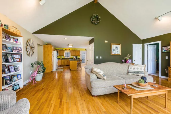 a kitchen with counter top space and wooden floor