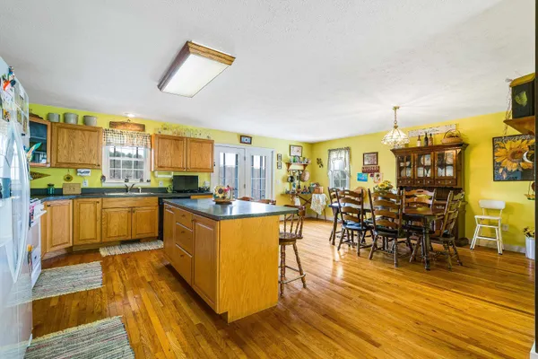 a kitchen with stainless steel appliances granite countertop a stove a refrigerator a kitchen island a stove and a refrigerator