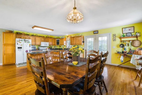 a spacious bedroom with a bed and a chandelier