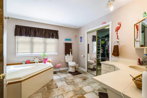 a view of walk in closet with clothes