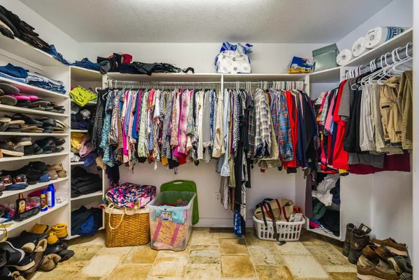 a bedroom with a bed and cabinets