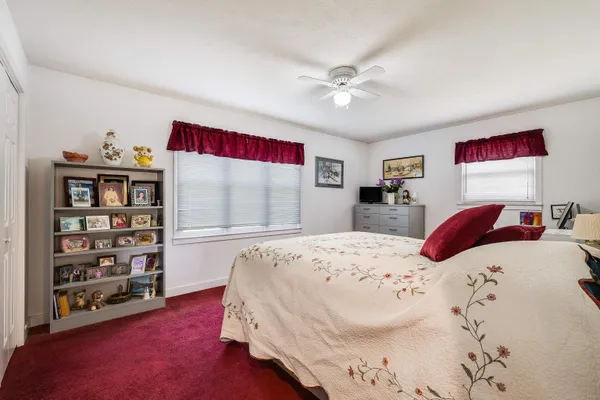 a bedroom with a bed and a dresser in it
