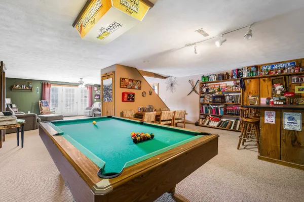 a view of a house with a patio and a yard