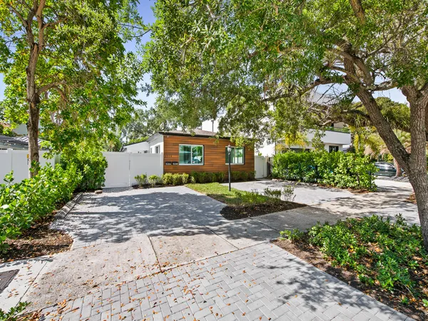 a view of a house with a tree and plants