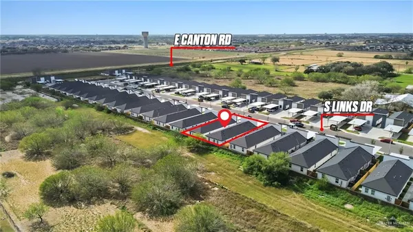 an aerial view of residential building and lake