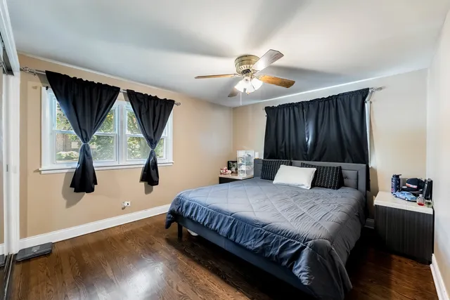a bedroom with a bed a window and a chandelier
