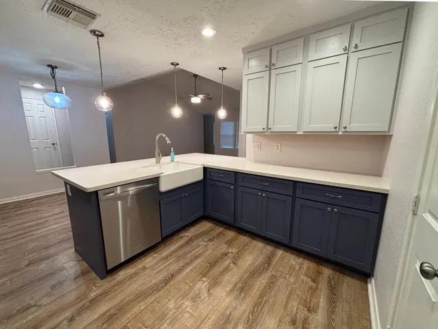 a kitchen with a sink and cabinets