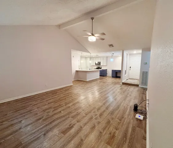 a view of a kitchen with a stove cabinets and wooden floor