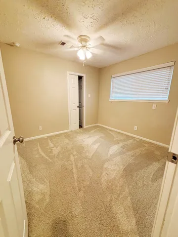 a view of a room with a ceiling fan