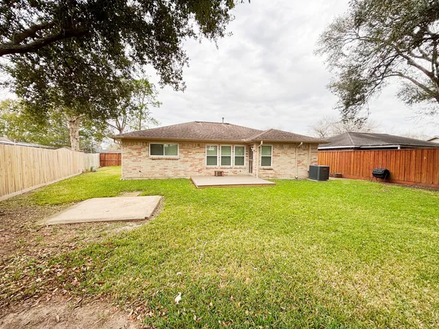 a view of a backyard with wooden fence