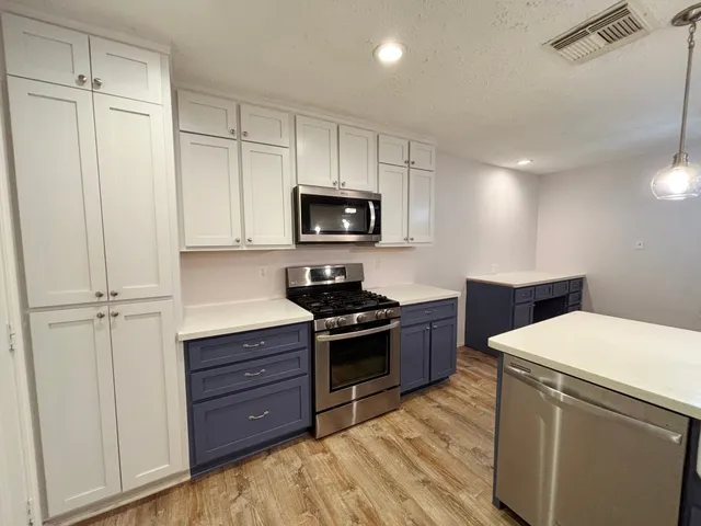 a kitchen with a stove microwave and a refrigerator