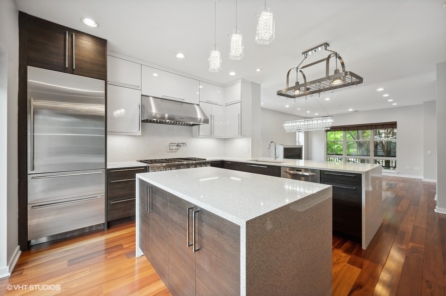 1231 West Arthington Street Chicago, IL 60607 - Photo 11 of 34 a kitchen with kitchen island a counter space a sink appliances and cabinets