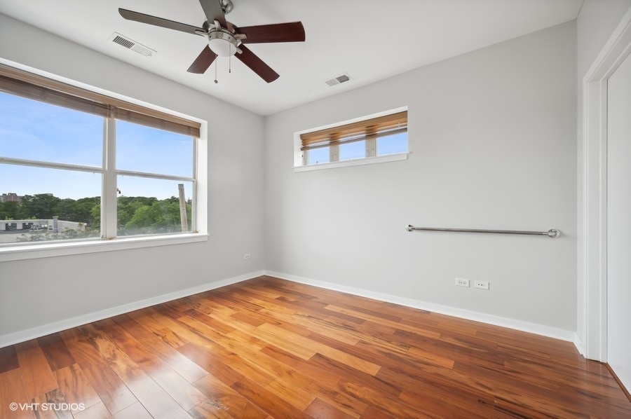 1231 West Arthington Street Chicago, IL 60607 - Photo 19 of 34 a view of empty room with wooden floor and fan