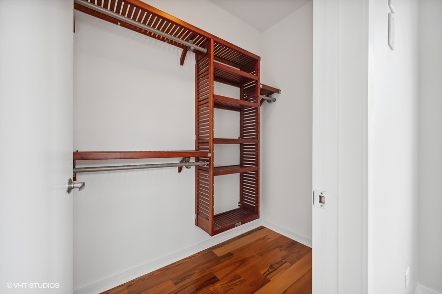 1231 West Arthington Street Chicago, IL 60607 - Photo 24 of 34 a view of a room with wooden floor and white walls