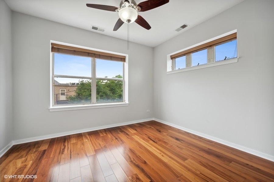 1231 West Arthington Street Chicago, IL 60607 - Photo 25 of 34 a view of an empty room with wooden floor and a window