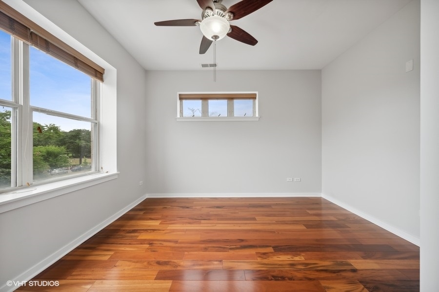 1231 West Arthington Street Chicago, IL 60607 - Photo 26 of 34 a view of empty room with wooden floor and fan