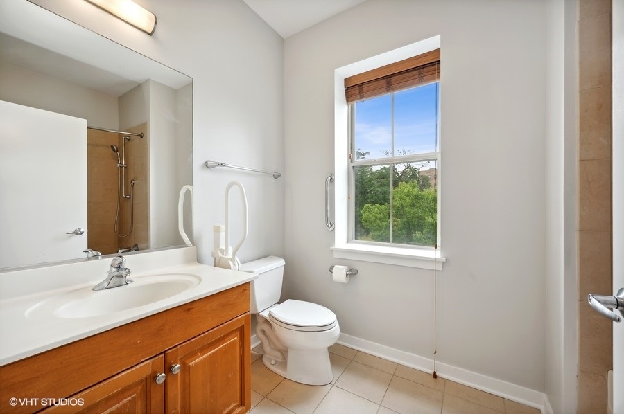 1231 West Arthington Street Chicago, IL 60607 - Photo 30 of 34 a bathroom with a toilet sink and mirror