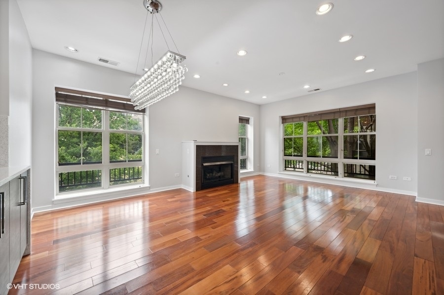 1231 West Arthington Street Chicago, IL 60607 - Photo 5 of 34 a view of an empty room with wooden floor and a window