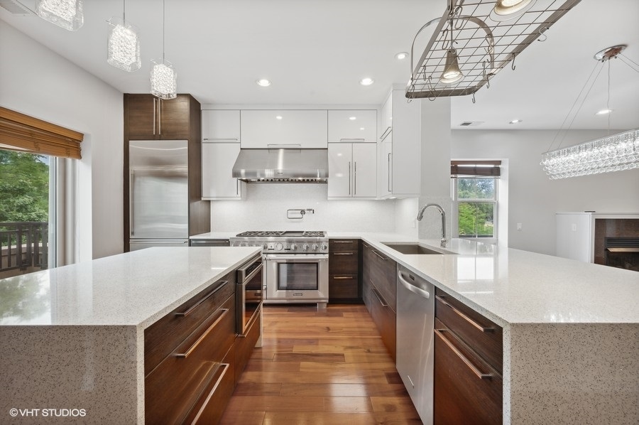1231 West Arthington Street Chicago, IL 60607 - Photo 8 of 34 a kitchen with stainless steel appliances granite countertop a sink stove and refrigerator