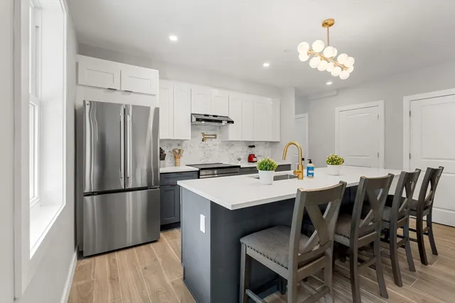 a kitchen that has a table and chairs in it