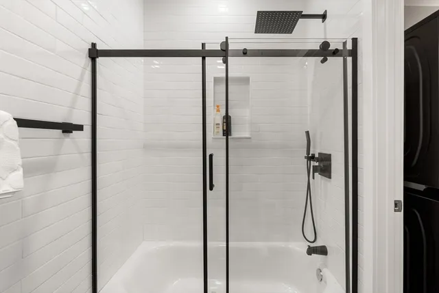 a bathroom with a glass shower door