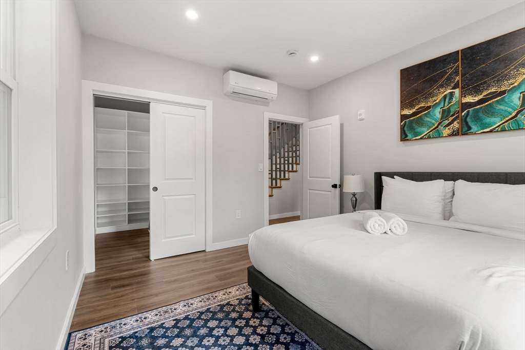 59 Perrin Street, Unit 1 Boston, MA 02119 - Photo 16 of 33 a bedroom with a bed and a walk in closet