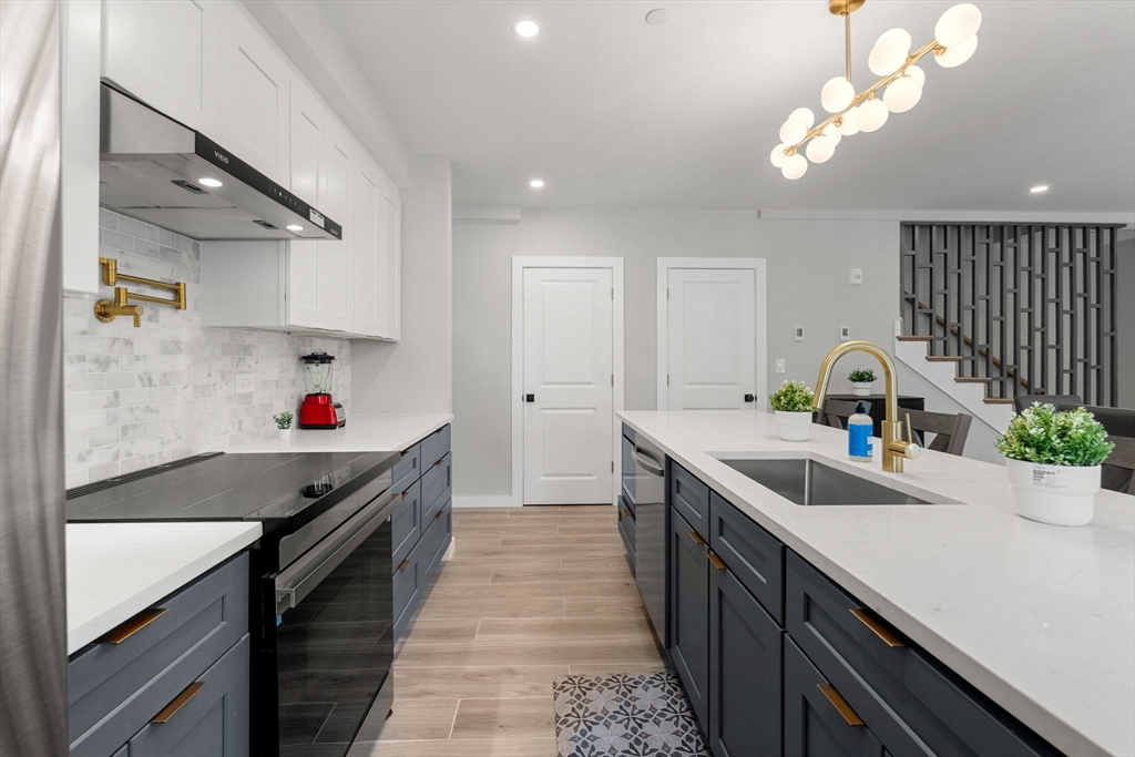 59 Perrin Street, Unit 1 Boston, MA 02119 - Photo 2 of 33 a kitchen with a sink a stove and cabinets