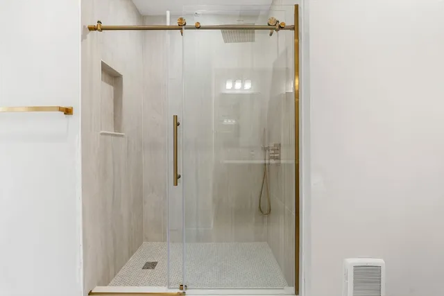 a bathroom with a shower and a bath tub