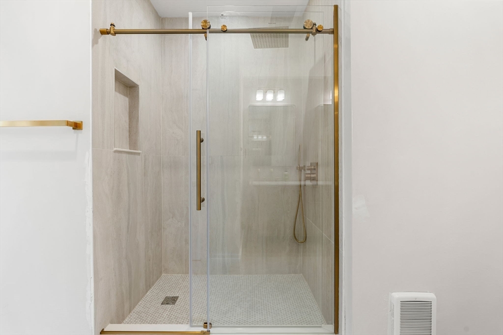 59 Perrin Street, Unit 1 Boston, MA 02119 - Photo 24 of 33 a bathroom with a shower and a bath tub