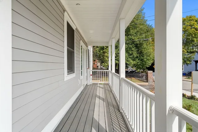 a view of a balcony with wooden floor