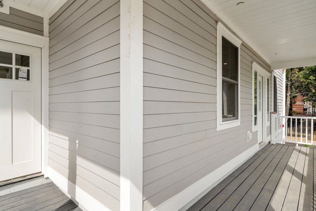 59 Perrin Street, Unit 1 Boston, MA 02119 - Photo 27 of 33 a view of a balcony with wooden floor and floor to ceiling window