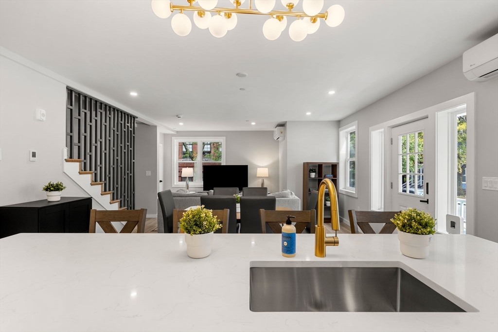 59 Perrin Street, Unit 1 Boston, MA 02119 - Photo 3 of 33 a living room with furniture a flat screen tv and a large window