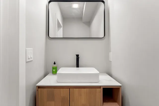 a bathroom with a sink and mirror