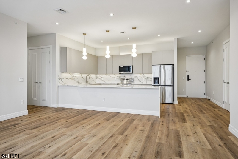 1722 Springfield Avenue, Unit 402 Maplewood, NJ 07040 - Photo 11 of 34 a view of kitchen with wooden floor