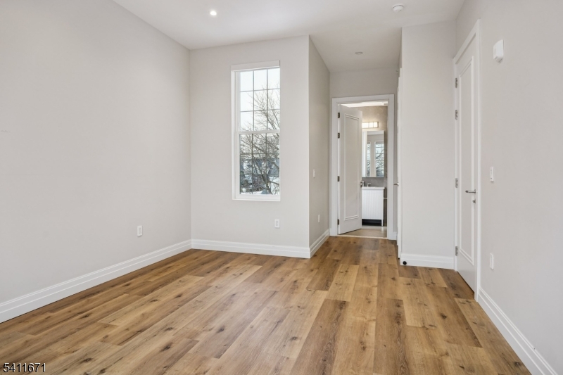 1722 Springfield Avenue, Unit 402 Maplewood, NJ 07040 - Photo 14 of 34 a view of empty room with wooden floor and fan