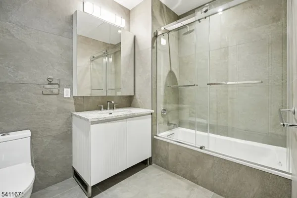 a kitchen with stainless steel appliances a microwave and a potted plant