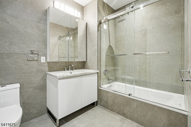 1722 Springfield Avenue, Unit 402 Maplewood, NJ 07040 - Photo 16 of 34 a bathroom with a bathtub and a shower