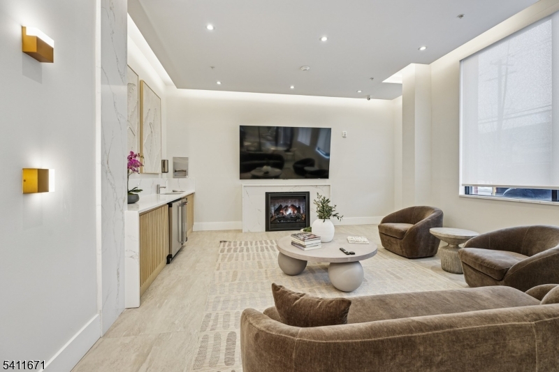 1722 Springfield Avenue, Unit 402 Maplewood, NJ 07040 - Photo 19 of 34 a living room with furniture and a flat screen tv