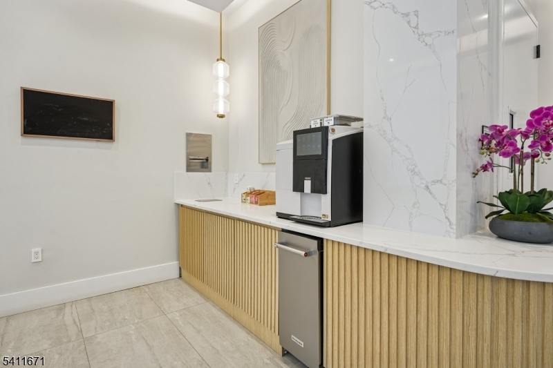 1722 Springfield Avenue, Unit 402 Maplewood, NJ 07040 - Photo 22 of 34 a kitchen with stainless steel appliances a microwave and a potted plant