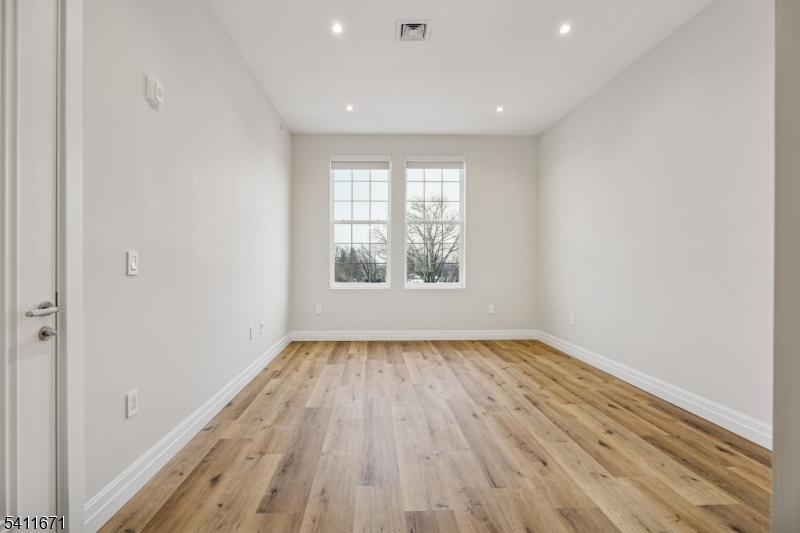 1722 Springfield Avenue, Unit 402 Maplewood, NJ 07040 - Photo 23 of 34 wooden floor in an empty room with a window
