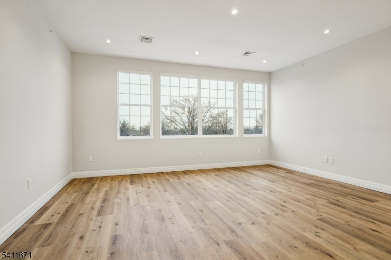 1722 Springfield Avenue, Unit 402 Maplewood, NJ 07040 - Photo 25 of 34 wooden floor in an empty room with a window