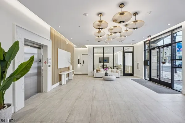a view of a hallway with wooden floor and glass door