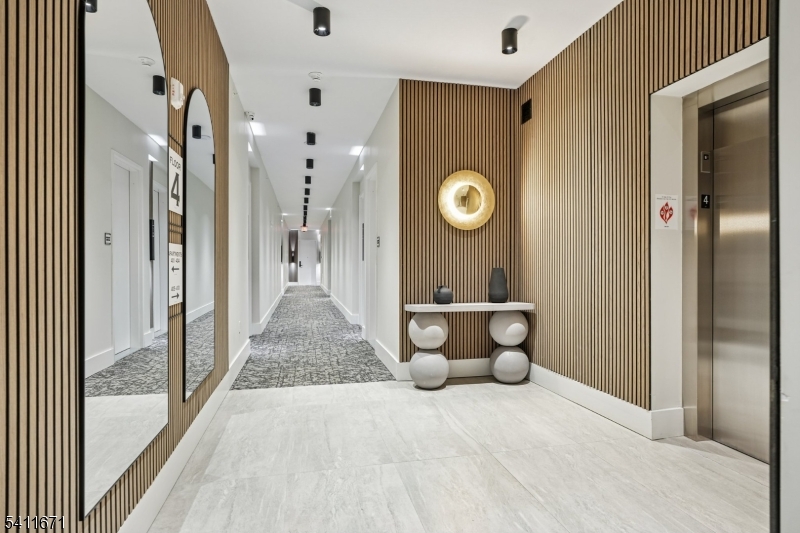 1722 Springfield Avenue, Unit 402 Maplewood, NJ 07040 - Photo 5 of 34 a view of a hallway with wooden floor and glass door