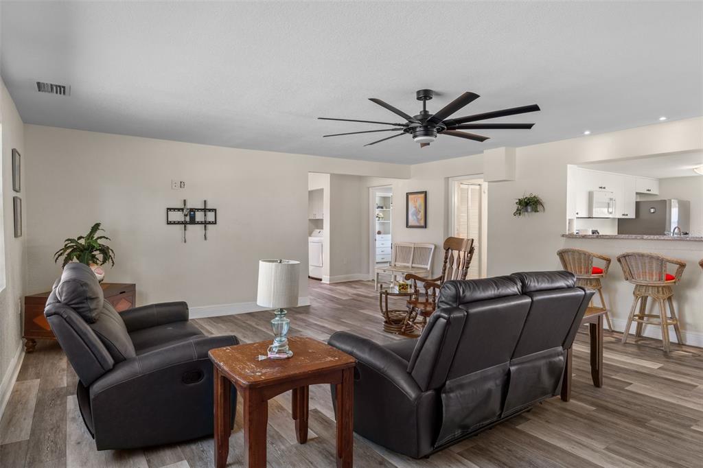 7272 Westwind Street Weeki Wachee, FL 34607 - Photo 11 of 33 a living room with furniture a table and a potted plant