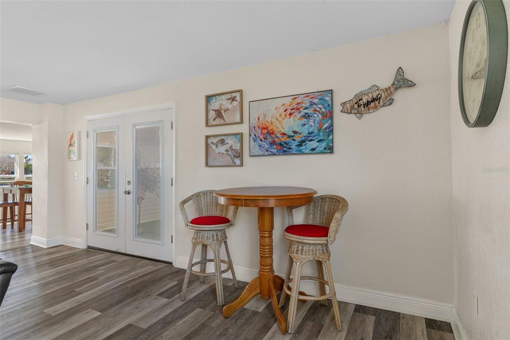 7272 Westwind Street Weeki Wachee, FL 34607 - Photo 12 of 33 a view of a room with wooden floor and a ceiling fan