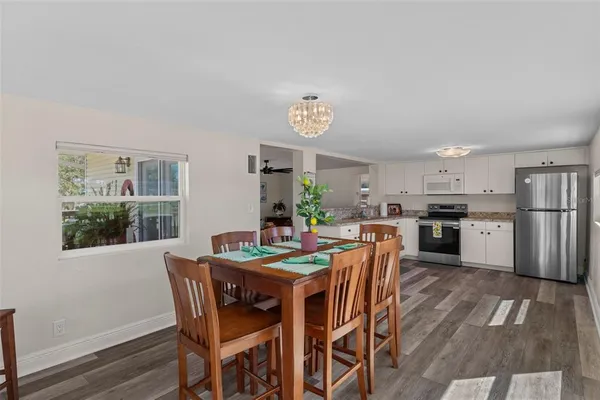 a view of a dining room with furniture window and wooden floor